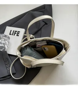 Top view of beige tote bag showing large interior capacity for umbrella and phone