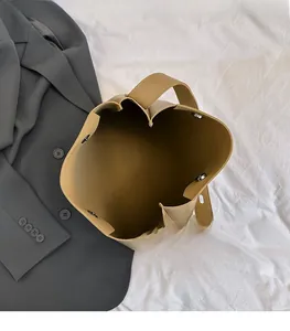 Detailed top view of large camel bucket bag interior with magnetic snap closure