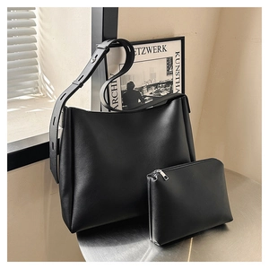 Detail of black PU leather bucket bag set with adjustable shoulder strap and small pouch