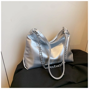 Detail of silver metallic tote bag with natural pleated texture and chain strap