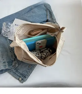Spacious interior of canvas tote bag with zipper pocket and daily essentials