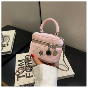 Détail du mini sac seau en cuir matelassé rose avec breloques argentées en fleur