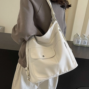Minimalist white large canvas tote bag with multiple pockets shown on model