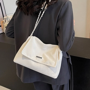 White faux leather tote bag with silver chain strap for versatile commuting and styling