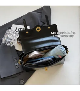 Interior view of black leather bag showing large capacity for phone and cosmetics