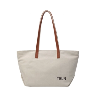 Minimalist canvas tote bag with brown leather handles and black TELN lettering print