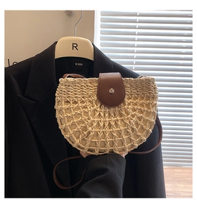 Detail of French straw weave shoulder bag featuring honeycomb texture and leather flap