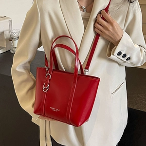 Glossy red faux leather tote bag with silver chain detail for women's daily commute