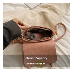 Top view of pink pebbled leather crossbody bag showing spacious interior with cosmetics