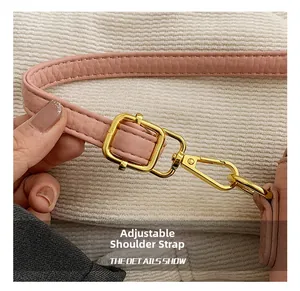 Macro detail of adjustable pink lychee leather strap with polished gold-tone lobster clasp