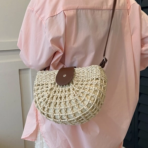 French straw woven tote bag with brown leather flap and adjustable shoulder strap