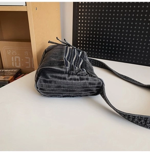 Detail view of washed denim tote with triple metal zipper pockets and Y2K street style design
