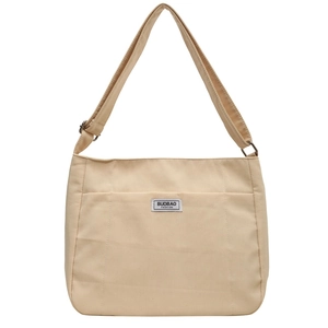Large beige canvas tote bag with adjustable shoulder strap and fashion label detail