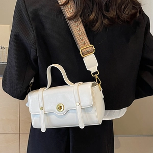 White faux leather crossbody bag with vintage gold lock and colorful woven strap