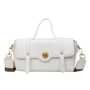 White leather crossbody bag with gold hardware and geometric patterned wide strap