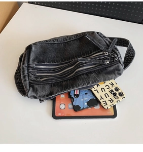 Macro detail of dark grey denim tote with multiple zippers and 11-inch tablet for scale