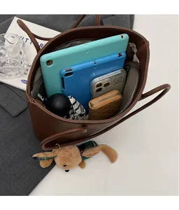 Spacious coffee tote bag interior holding two tablets, a wallet and an umbrella