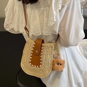 French woven straw shoulder bag with leather trim and cute cat charm for beach vacation