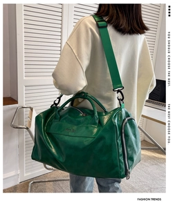 Detail of light green PU leather gym bag featuring double handles and adjustable strap