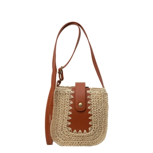 Large woven straw shoulder bag with brown leather trim for summer beach vacations