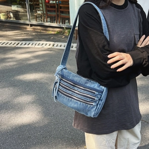 Retro denim tote bag with triple zipper detail and adjustable strap for casual street style