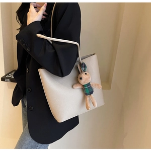 Shoulder tote bag in cream lychee texture leather with a green plaid bunny plush charm
