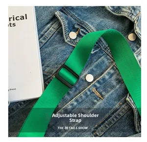 Close-up of bright green adjustable high-density nylon shoulder strap on denim