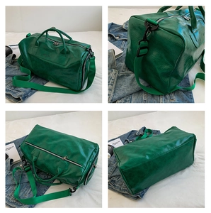Detail view of green leather travel bag showing sturdy handles and adjustable strap