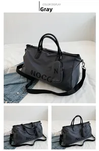 Detailed view of gray nylon duffel bag with black handles and NOCO logo print