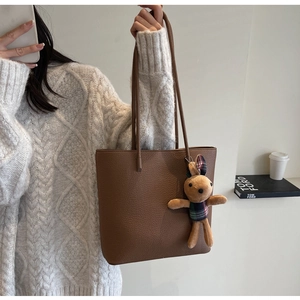 Brown litchi leather tote bag with cute rabbit charm detail for casual daily wear