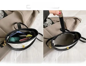 Detail view of cream saddle bag interior capacity with metal lock and leather edges