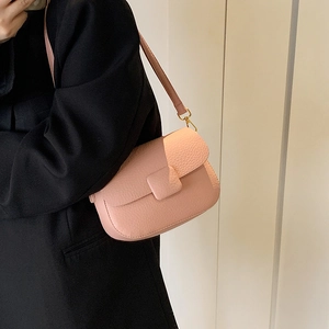 Pink lychee texture half-moon crossbody bag with gold metal hardware on model