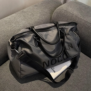 Large dark grey waterproof travel duffel bag with leather handles and coin pouch
