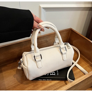 Detail of off-white mini Boston bag with textured leather and silver-tone hardware