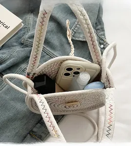 Top view showing the internal storage capacity of the woven straw mini crossbody bag