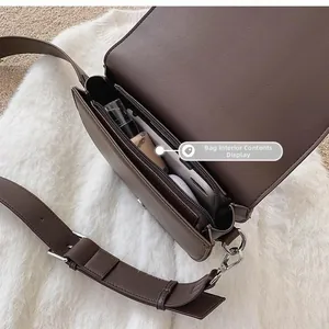 Macro view of dark brown leather saddle bag interior showing spacious compartments