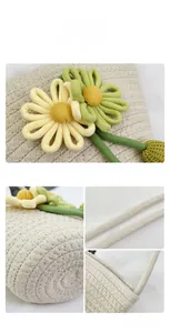 Close-up of woven straw bucket bag with floral daisy applique and rope strap texture