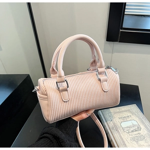 Detail of pink corduroy mini Boston bag with silver hardware and adjustable strap