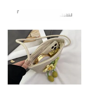 Detail view of woven straw bucket bag with floral decor and internal storage capacity