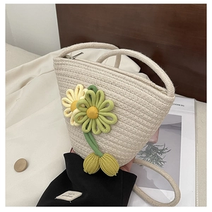 Detail of woven straw bucket bag with 3D fabric flowers and secure metal zipper