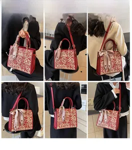 Red bridal tote with gold embroidery and decorative scarf shown in various carry styles