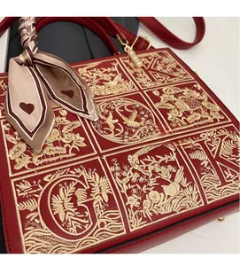 Detail of red wedding handbag with exquisite gold embroidery and decorative silk scarf