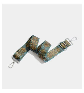 Close-up of adjustable woven bag strap with vintage geometric patterns and silver hardware
