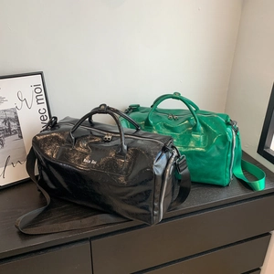 Large travel duffel bag with wet-dry separation in black and green crinkled patent leather
