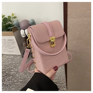 Pink woven mini crossbody bag with gold metallic clasp and structured boxy design