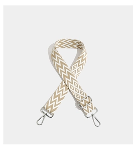Detail of adjustable geometric embroidered bag strap with silver metal lobster clasps