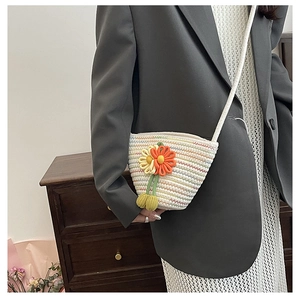 Detail of woven straw mini bag with 3D orange flowers and colorful stripe patterns