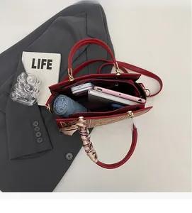 Top view of red leather bridal bag with silk scarf showing large capacity for essentials