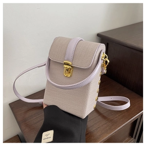 Detail of lavender woven texture mini crossbody bag with gold metallic clasp lock