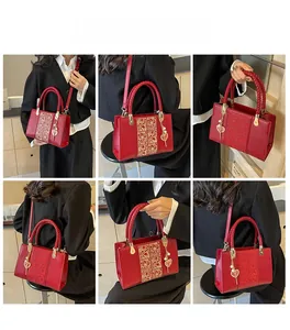 Detailed views of red bridal handbag with gold embossing and heart pendant detail